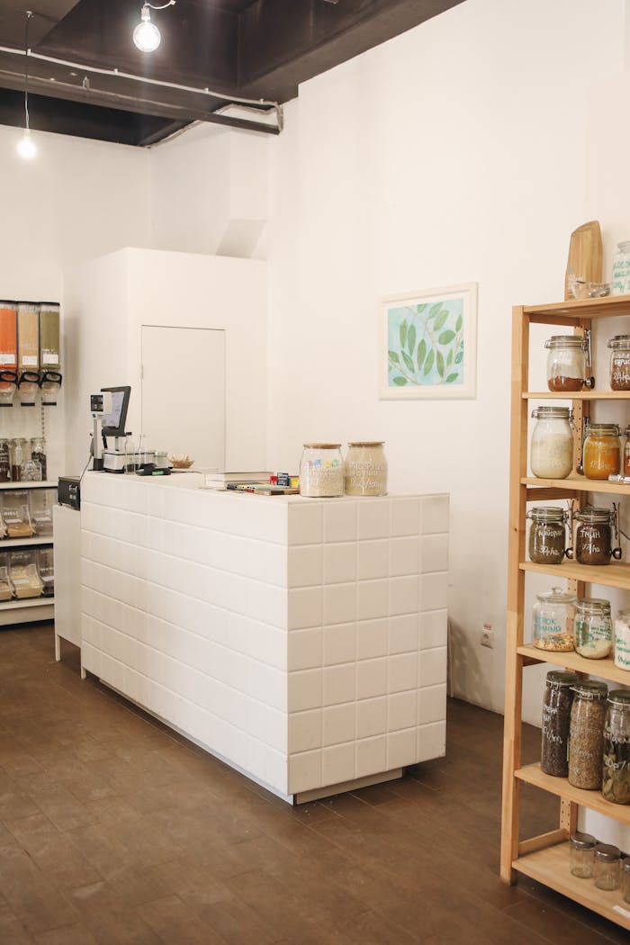services-03 Bright minimalistic zero waste store interior with wooden shelves and sustainable products displayed.