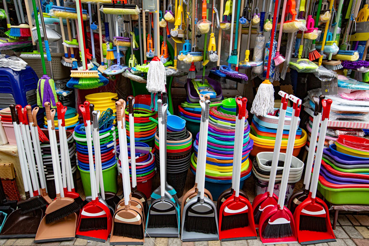 gallery-6 From above various sets of broom and scoop placed in household goods store near colorful basins and bins